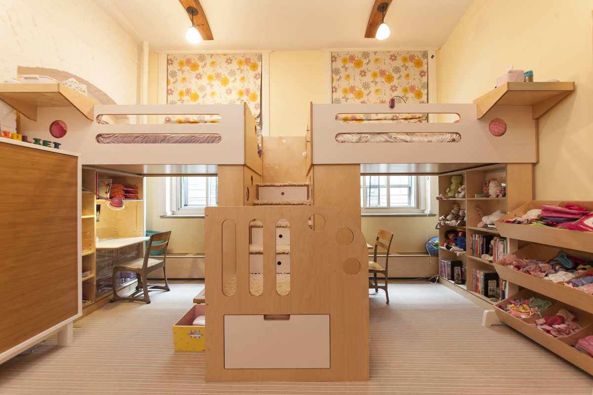 Two-loft-beds-sharing-a-central-staircase