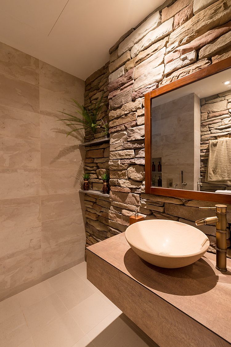 Tropical-style-powder-room-with-a-stacked-stone-wall