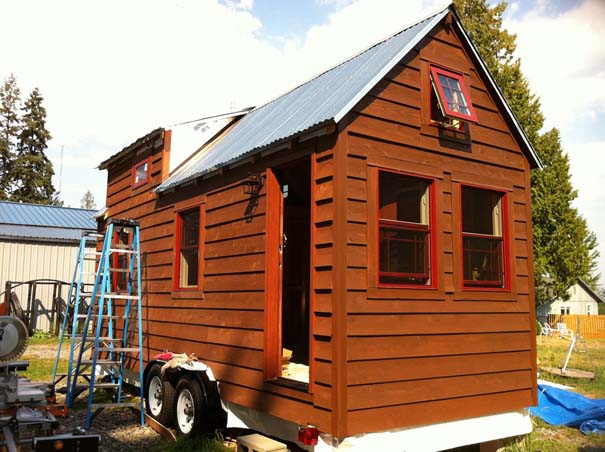 Malissa and Christopher Tack live in a perfect miniature home in Snohomish, Washington, which they built themselves taking a little over seven months. The couple have named their cottage-on-wheels The Tiny Tack House, a 140 sq. ft. wooden structure which is complete with living room, kitchen, bathroom and a sleeping loft. They had very little knowledge of how to build a house when they took on the project in order to 'downsize' 'The work was done by Chris and myself. There was a few days where the parents flew in to help out with the roof", said Malissa. 'We had advice help with the electrical and plumbing from a certified person'. 'Just about everyone we know thought we were crazy, but now, everyone loves the idea of the house!' The house has four solar panels and is supplied by a 40 gallon fresh water tank, making it environmentally, as well as financially, friendly. Pictured: Tiny House Ref: SPL480656 180113 Picture by: Splash News Splash News and Pictures Los Angeles: 310-821-2666 New York: 212-619-2666 London: 870-934-2666 photodesk@splashnews.com 