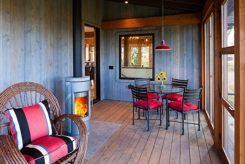 screen-porch-sunroom-with-fireplace-and-colorful-decor