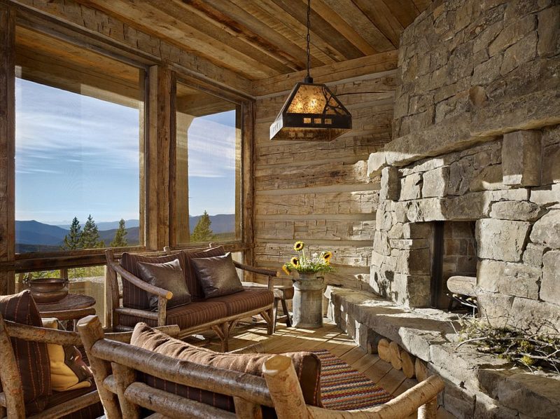 view-outside-the-window-and-stone-walls-shape-an-idyllic-rustic-sunroom